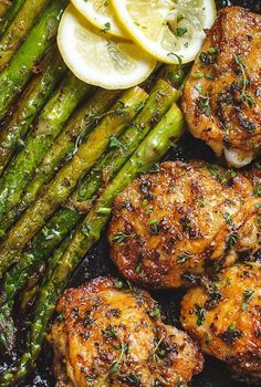 grilled chicken and asparagus with lemon wedges