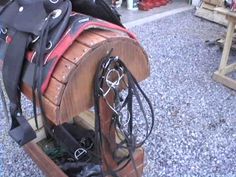 there are many different types of saddles on this stand, including one for the horse