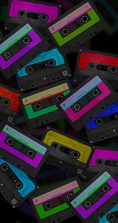 a pile of colorful cassette tapes sitting on top of each other