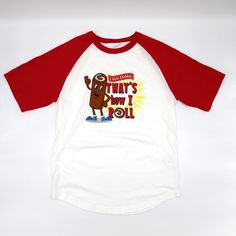 Front view of the Little Debbie Swissy 'That's How I Roll' T-shirt, featuring Swissy the mascot, and the phrase 'That's How I Roll' prominently displayed on the front, with radiant red raglan sleeves. Red Cotton Novelty T-shirt, Red Novelty Cotton T-shirt, White Novelty Cotton T-shirt, White Cotton Novelty T-shirt, Swiss Rolls, Little Debbie, Playful Style, Swiss Roll, Free Label