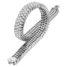 Experience the epitome of luxury with the Geraldo 14.2 Carat 3 Row Diamond White Gold Invisible Setting Bracelet, a true masterpiece of jewelry design. This stunning bracelet features a seamless design that showcases 14.2 carats of f/vs-vvs diamonds, all set in a combination of invisible settings. The diamonds used in this bracelet are of the highest quality, and the bracelet is crafted from the finest 18-carat white gold for a timeless and elegant look. This bracelet's unique invisible setting Luxury Flexible Diamond Bracelet In White Gold, Luxury Flexible Round Tennis Bracelet, Luxury Flexible Diamond Bracelet For Anniversary, Vvs Diamond, Modern Bracelets, White Gold Bracelet, White Gold Necklaces, 2 Carat, To Shine