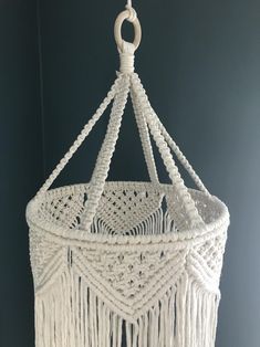 a white macrame hanging from a ceiling