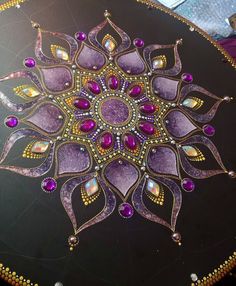 an intricately designed table top with purple stones