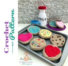 some crocheted cookies are on a tray