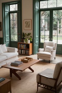 a living room filled with white furniture and green window panes in front of them