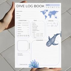 someone holding up a blue and white dive log book