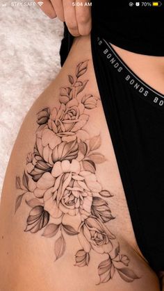 a woman's stomach with flowers on it and the bottom half of her body