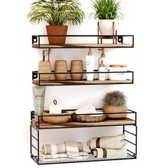 three tiered shelving unit with plants and other bathroom items on top of it