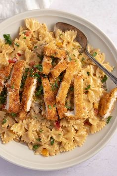 a white plate topped with pasta and chicken