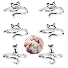 six different types of rings with cats'heads and tails on them, all in various sizes