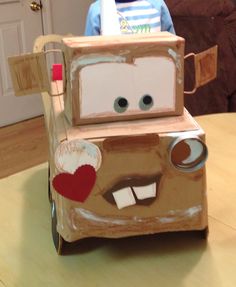 a child's cardboard car made to look like the character cars from disney pixar