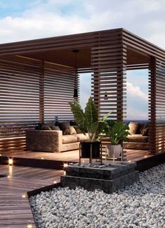 an outdoor living area with wooden slatted walls and seating on the decking