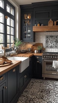 a kitchen with black cabinets and white tile