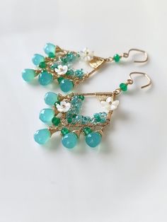 This romantic pair of earrings is composed of blue chalcedony and green onyx, embellished with some white mother of pearl flowers, turquoise, apatite, and some seed beads. The overall look is very refreshing and romantic. ●blue chalcedony ●onyx ●turquoise ●apatite ●mother of pearl flowers ●seed beads ●14k gold filled ● total length approximately: 2.67 inches ● weight：5.2g Welcome to visit my Jewelry store: https://www.etsy.com/shop/Ukuly 🌸The delivery time to Most regions of North America, Australia and Europe is usually about 10-15 days. Buyers from Brazil, South Korea, and Indonesia, please provide me with your tax number through messages or notes for smooth shipment. Thank you. 🌸Please let me know your phone number when you place an order. It will be used for shipping label only. 🌸I Blue Gemstone Chandelier Earrings For Gifts, Gemstone Chandelier Earrings As Gift, Handmade Green Chandelier Earrings For Celebration, Handmade Teardrop Chandelier Earrings For Anniversary, Handmade Turquoise Briolette Earrings, Elegant Handmade Turquoise Chandelier Earrings, Briolette Gemstone Chandelier Earrings As Gift, Handmade Turquoise Chandelier Earrings, Unique Earrings Gold