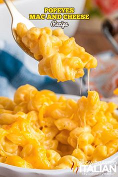 macaroni and cheese being lifted from a white bowl