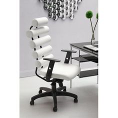 a white office chair sitting in front of a desk with a clock on the wall