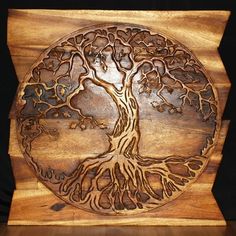 a wooden plaque with a tree on it