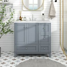 a bathroom with a sink, mirror and plants in the corner on the counter top