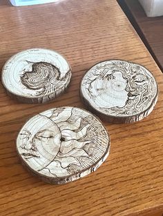 three wooden coasters sitting on top of a table