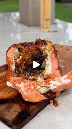 a piece of meat sitting on top of a wooden cutting board