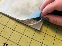 someone cutting fabric with a pair of scissors