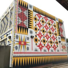 a large colorful building with geometric designs painted on it