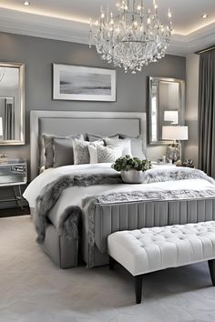 a large bed sitting in a bedroom next to a chandelier