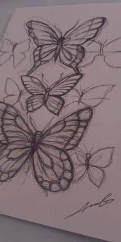 a drawing of three butterflies on a piece of paper