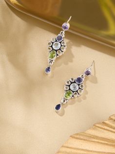 These stunning earrings are crafted from high-quality 92.5 sterling silver and feature a dazzling array of gemstones, including Amethyst, Iolite, Citrine, Peridot, and Blue Topaz. Each stone’s vibrant color creates a beautiful spectrum, making these earrings a versatile and eye-catching accessory. Perfect for adding a touch of elegance and color to any outfit, they’re ideal for both everyday wear and special occasions. Silver Amethyst Multi-stone Earrings, Silver Amethyst Earrings With Multi-stone, Sterling Silver Earrings With Stones, Silver Multi-stone Dangle Gemstones, Fusion Multi-stone Sterling Silver Earrings, Fusion Style Multi-stone Sterling Silver Earrings, Fusion Sterling Silver Multi-stone Earrings, Stunning Earrings, Blue Topaz