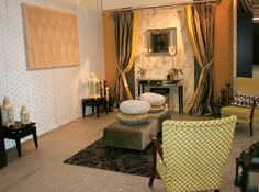 a living room filled with lots of furniture next to a wall covered in curtains and drapes