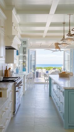 the kitchen is clean and ready to be used for cooking or eating, with an ocean view in the background