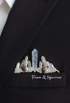 a man wearing a suit and tie with three crystal pins in his lapel pin