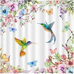 a shower curtain with colorful flowers and butterflies on the bottom, and two hummingbirds flying over them