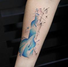 a woman's arm with a watercolor tattoo on it