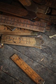 an old wooden floor with several rulers on it