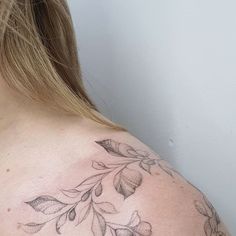 a woman with a tattoo on her shoulder