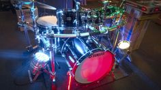 a drum set with lights on it in a room