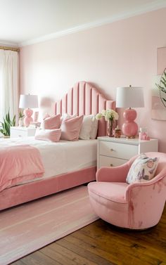 a bedroom with pink walls and furniture