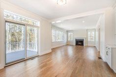 an empty living room with hard wood floors