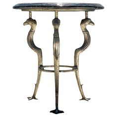 an ornate metal table with two birds on it