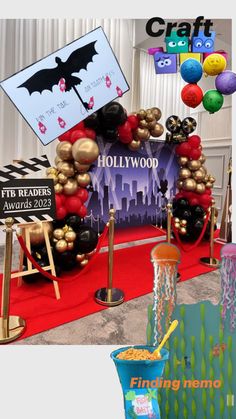 the entrance to hollywood studios is decorated with balloons and streamers for an award ceremony