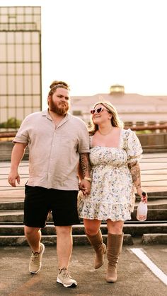 a man and woman are walking together in the parking lot