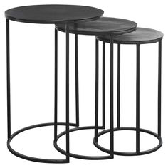 three black tables with metal bases on each side and one has a round top, the other