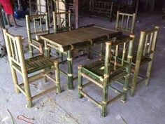 a table and chairs made out of bamboo are sitting in the middle of a room