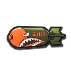 an orange and green rocket with a shark's teeth on it