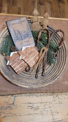 a wooden plate topped with lots of different types of christmas decorations on top of a table