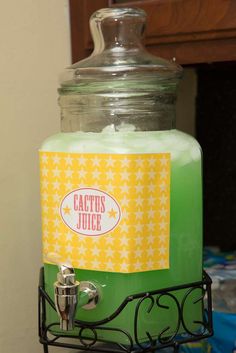 a glass jar filled with liquid sitting on top of a metal rack next to a wall