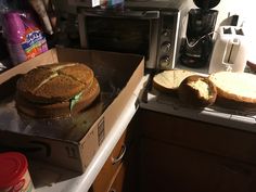 an open box sitting on top of a counter next to two pieces of bread in front of a toaster oven