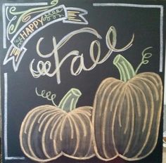 a chalkboard sign that says happy fall and two small pumpkins on the front