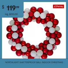 a red and white christmas wreath with balloons